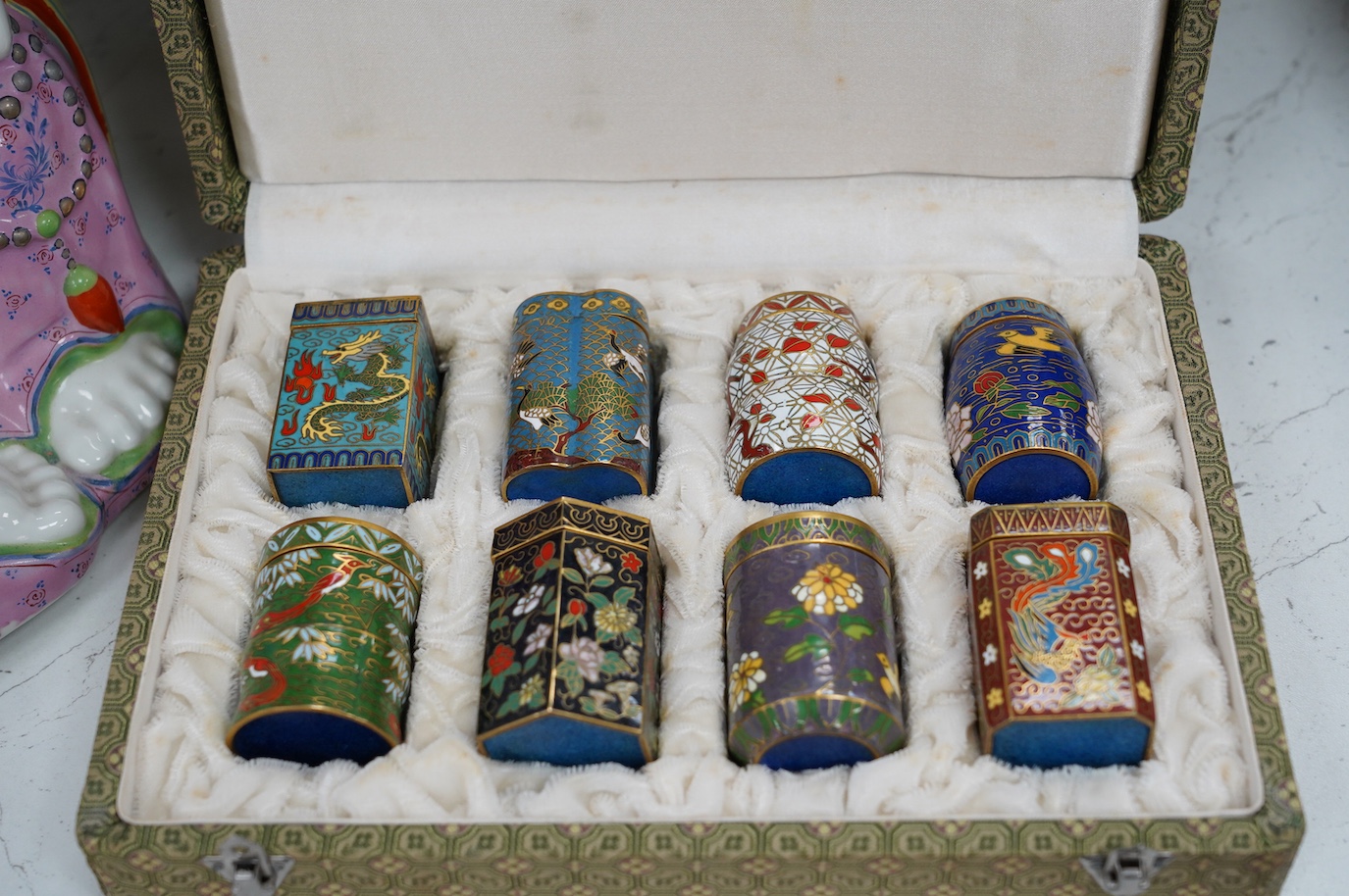 A 20th century Chinese famille rose Buddha, a ‘hundred boys’ vase and a boxed set of cloisonné boxes, vase 34cm. Condition - cloisonné boxes good, Buddha has missing decoration to robe near right hand and vase good